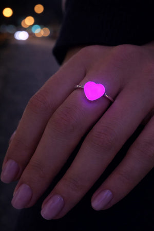 Justerbar hjärtring i rostfritt stål som lyser rosa/lila i mörker på hand
