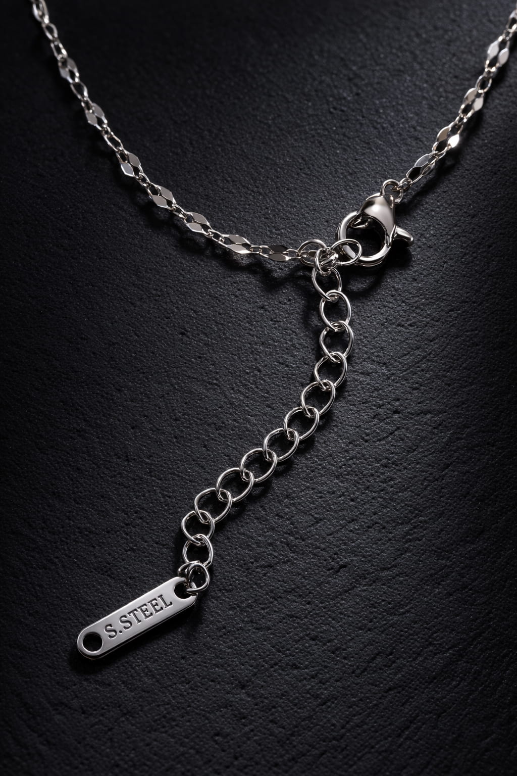 Detaljbild av elegant kedja i rostfritt stål med karbinlås och 5 cm förlängningskedja